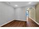 Bright bedroom with wood flooring, striped wallpaper and access to a hallway at 2229 Earleaf Ct, Longwood, FL 32779