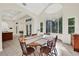Bright dining room with wood table and chairs, surrounded by windows at 2229 Earleaf Ct, Longwood, FL 32779