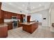 Kitchen with island, stainless steel appliances, and wood cabinets at 2229 Earleaf Ct, Longwood, FL 32779