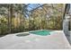 Screened pool and spa with lush wooded backdrop at 2229 Earleaf Ct, Longwood, FL 32779