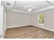 Spacious bedroom with wood-look flooring and a window at 25 Locust Loop Ln, Ocala, FL 34472