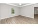 Bright bedroom with wood-look flooring and ceiling fan at 25 Locust Loop Ln, Ocala, FL 34472