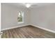 Simple bedroom with wood-look floors and a window at 25 Locust Loop Ln, Ocala, FL 34472
