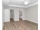 Spacious main bedroom with wood-look floors and ensuite bathroom access at 25 Locust Loop Ln, Ocala, FL 34472