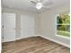 Spacious bedroom with ceiling fan and window at 25 Locust Loop Ln, Ocala, FL 34472