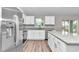 Modern kitchen with white cabinets, granite counters, and stainless steel appliances at 25 Locust Loop Ln, Ocala, FL 34472