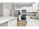 Modern kitchen with stainless steel appliances and granite countertops at 25 Locust Loop Ln, Ocala, FL 34472