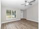 Bright living room with vinyl plank flooring and a large window at 25 Locust Loop Ln, Ocala, FL 34472