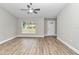 Spacious living room with vinyl plank flooring, large window, and ceiling fan at 25 Locust Loop Ln, Ocala, FL 34472