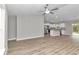 Open floor plan with kitchen, island, and living room, wood-look flooring, and recessed lighting at 25 Locust Loop Ln, Ocala, FL 34472