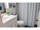 Clean bathroom with white vanity and a blue shower curtain at 293 Scottsdale Sq # 293, Winter Park, FL 32792