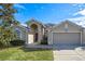 Two-story house with a two-car garage and well-maintained lawn at 330 Ballyshannon Dr, Davenport, FL 33897