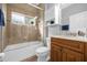 Clean bathroom with a tub shower combo and wood vanity at 3621 Daydream Pl, Saint Cloud, FL 34772