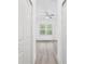Hallway connecting to bedrooms with white doors and wood floors at 406 Marion Oaks Pass, Ocala, FL 34473