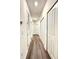 Long hallway with light walls and wood-look flooring at 4736 Tribute Trl, Kissimmee, FL 34746