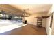 Garage with open overhead door, shelving, and light-colored floor at 533 Shining Armor Ln, Longwood, FL 32779