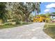 House exterior showcasing landscaping and a paver driveway at 5423 Kenmore Ln, Orlando, FL 32839