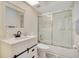 Simple bathroom with white vanity, a large mirror and a shower/tub combo at 545 Brown Pelican Dr, Daytona Beach, FL 32119