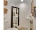 Stylish bathroom with pedestal sink, full-length mirror, and modern fixtures at 545 Brown Pelican Dr, Daytona Beach, FL 32119