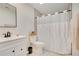 Updated bathroom with white vanity, shower/tub combo, and gray flooring at 545 Brown Pelican Dr, Daytona Beach, FL 32119