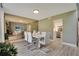 Modern dining room with white table and chairs, and view into kitchen at 545 Brown Pelican Dr, Daytona Beach, FL 32119