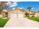 Tan two-story townhouses with two-car garages and manicured lawns at 545 Brown Pelican Dr, Daytona Beach, FL 32119