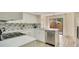Updated kitchen featuring white shaker cabinets and a breakfast bar at 545 Brown Pelican Dr, Daytona Beach, FL 32119