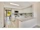 Modern kitchen with white cabinets, quartz countertops, and stainless steel appliances at 545 Brown Pelican Dr, Daytona Beach, FL 32119