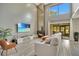 Bright living room with a fireplace, large TV, and lots of natural light at 545 Brown Pelican Dr, Daytona Beach, FL 32119
