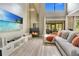 Spacious living room with a fireplace, large TV, and sliding glass doors at 545 Brown Pelican Dr, Daytona Beach, FL 32119