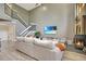 Living room with fireplace, large sectional sofa, and high ceilings at 545 Brown Pelican Dr, Daytona Beach, FL 32119