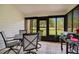 Screened porch with patio furniture and grill overlooking a tranquil scene at 545 Brown Pelican Dr, Daytona Beach, FL 32119