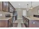 Modern kitchen featuring dark wood cabinets and granite countertops at 600 Northern Way # 801, Winter Springs, FL 32708