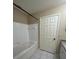 Bathroom with a bathtub, shower, and white tile at 6348 Raleigh St # 1311, Orlando, FL 32835