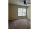 Bright bedroom with carpet, large window, and ceiling fan at 6348 Raleigh St # 1311, Orlando, FL 32835
