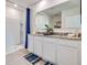 Double vanity bathroom with granite countertop, shower, and walk-in closet at 7110 Painted Bunting Way, Saint Cloud, FL 34773