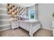 Charming bedroom with twin bed and striped wall at 7110 Painted Bunting Way, Saint Cloud, FL 34773