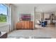 Living room with TV stand, offering a view of the dining area at 7110 Painted Bunting Way, Saint Cloud, FL 34773