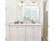 Double vanity bathroom with a large mirror and shower at 8019 Knee Deep Rd, Kissimmee, FL 34747