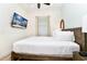 Bedroom with a queen bed, mounted TV and nightstand at 8019 Knee Deep Rd, Kissimmee, FL 34747