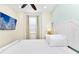 Bright bedroom with a queen bed, TV, and ceiling fan at 8019 Knee Deep Rd, Kissimmee, FL 34747