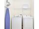 Laundry room with washer, dryer, and shelving at 8019 Knee Deep Rd, Kissimmee, FL 34747