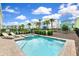 Community pool with lounge chairs and homes at 8019 Knee Deep Rd, Kissimmee, FL 34747