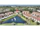 Aerial view of townhomes community with a central lake at 8145 Roseville Blvd, Davenport, FL 33896
