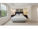 King-size bed in bright bedroom with window at 8145 Roseville Blvd, Davenport, FL 33896