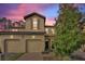 Tan two-story townhome with two-car garage, and landscaped front yard at 8145 Roseville Blvd, Davenport, FL 33896