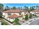 Tan three-story townhouse with tile roof and two-car garage at 8145 Roseville Blvd, Davenport, FL 33896