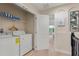 Laundry room with washer, dryer, and shelving at 8145 Roseville Blvd, Davenport, FL 33896