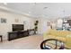 Living room with yellow couch and flat-screen TV at 8145 Roseville Blvd, Davenport, FL 33896
