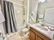 Bathroom with single vanity, shower/tub combo, and gray decor at 8848 Candy Palm Rd, Kissimmee, FL 34747